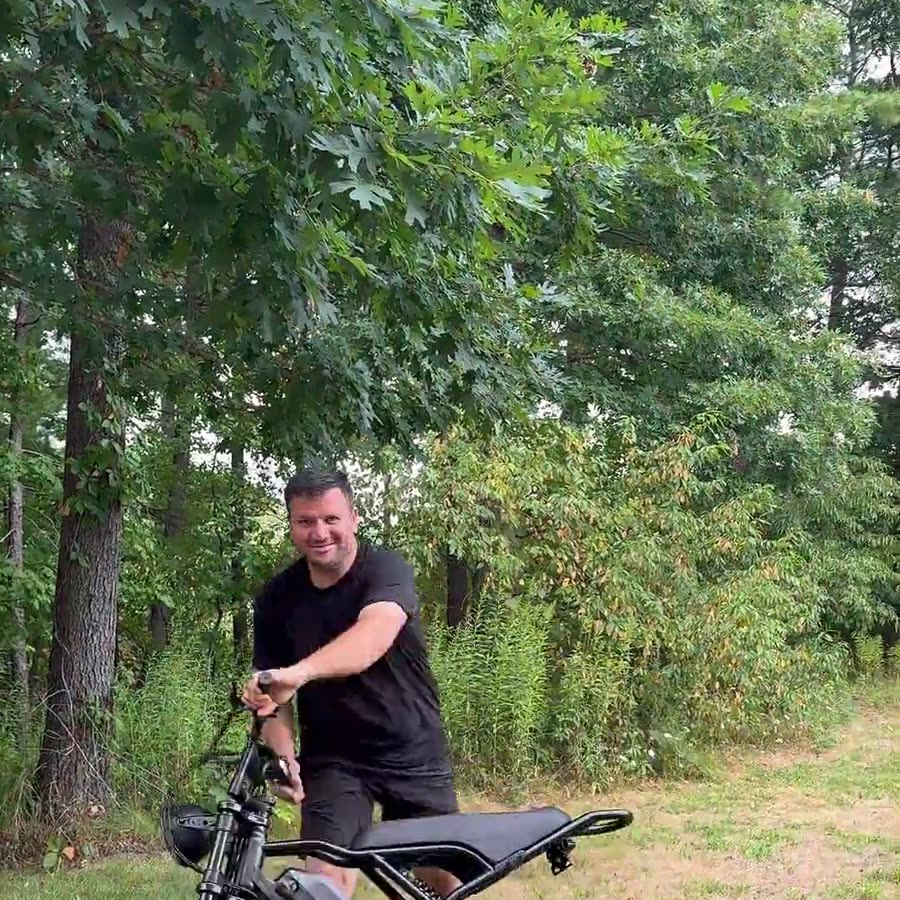 Sahin Akcal riding an e-bike on location